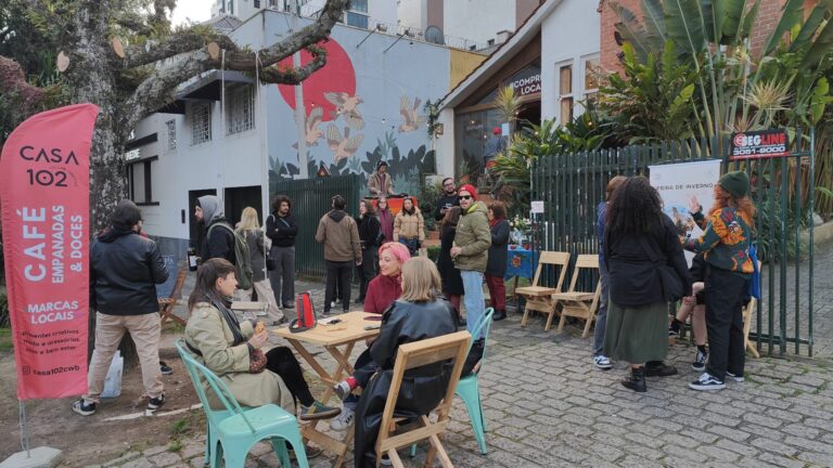 Visitantes circulam pela Feira da Casa 102 no Centro Histórico de Curitiba durante evento com gastronomia, música e marcas autorais.